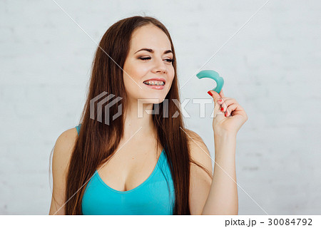 Girl boxer with braces holding gloves and cape 30084792