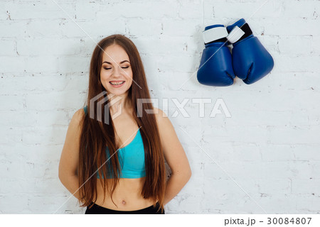 Woman with braces resting after a workout Woman with braces resting after a workout 30084807