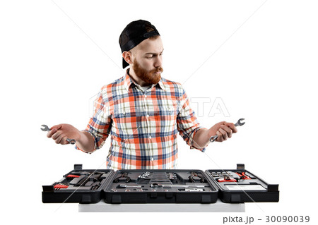the young bearded man hold a repair tools 30090039