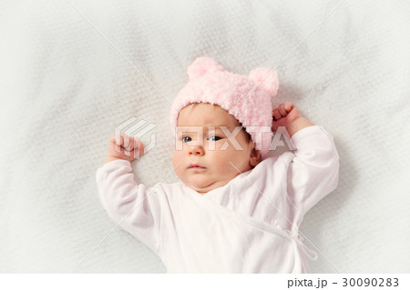 Cute newborn baby girl lying in the bed Cute newborn baby girl lying in the bed 30090283