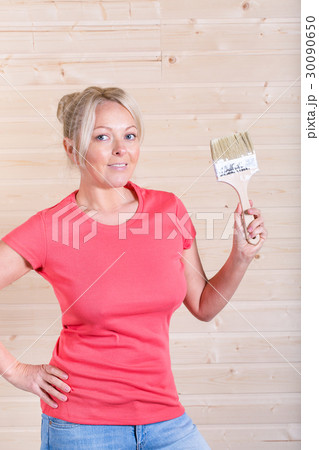 Woman with paint brush in hand 30090650