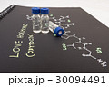 Close-up blue cap sample vial on paper  30094491