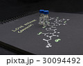 Close-up blue cap sample vial on paper 30094492