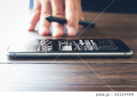 smartphone on desk, concept working through phone. 30103409