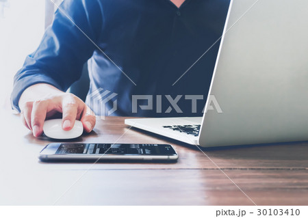 businessman hand working laptop on wooden desk. businessman hand working laptop on wooden desk. 30103410