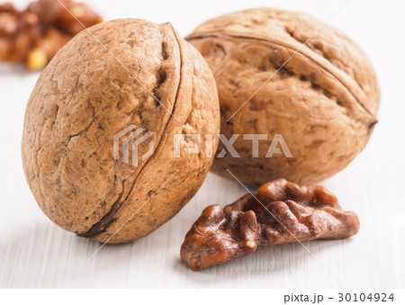 inshell walnut on white wooden background inshell walnut on white wooden background 30104924