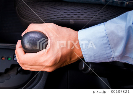 A business man holding gear 30107321