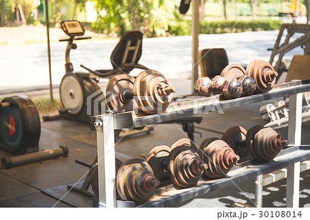 Rows of metal dumbbells on rack in the gym 30108014