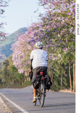man touring bicycle rider on the urban road man touring bicycle rider on the urban road 30110430