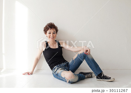 the girl with the short hair sitting on the floor 30111267