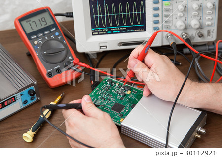 Engineer's hands holding probes Engineer's hands holding probes 30112921