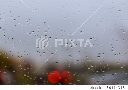 Close up of the raindrops on the glass with blur 30114313