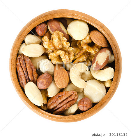 Raw mixed nuts in wooden bowl over white 30118155