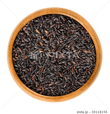 Organic black rice in wooden bowl over white 30118156