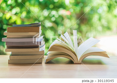 Open book on wood planks over blur background Open book on wood planks over blur background 30119345
