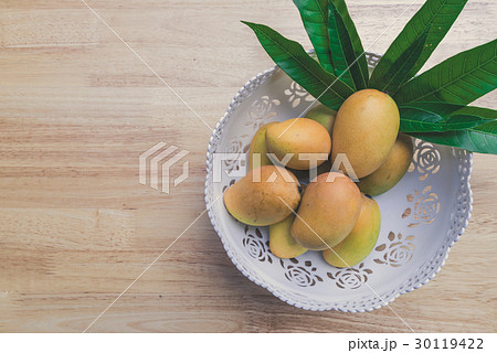Mango on a wood background Mango on a wood background 30119422