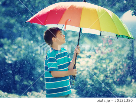 Child walking on rainy weather 30121380
