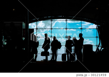 Silhouettes of people waiting for their flight at Silhouettes of people waiting for their flight at 30121459