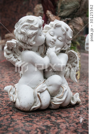 closeup of white angel in cemetery on a tomb closeup of white angel in cemetery on a tomb 30125562