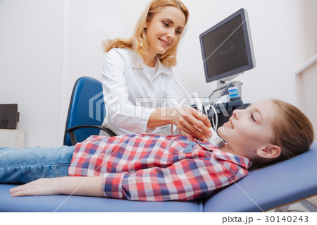 Optimistic young patient having ultrasound thyroid 30140243