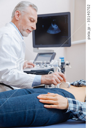 Handsome aged doctor having appointment in the 30140702