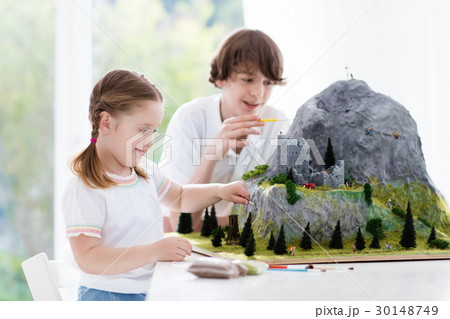 Kids working on model building project for school 30148749
