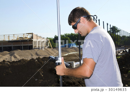 Geodesist working at a new village stadium Geodesist working at a new village stadium 30149635