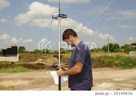 Geodesist working on a terrain Geodesist working on a terrain 30149636