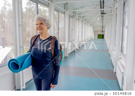 Happy retiree going in hall after training 30149816