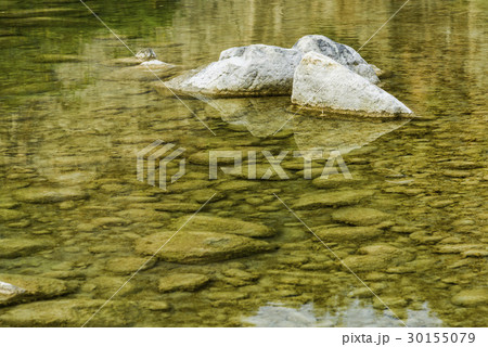 Rocky bottom of brook close-up as background. 30155079