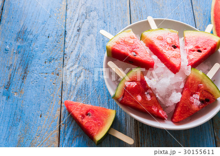 Watermelon slice popsicles on a blue rustic wood 30155611