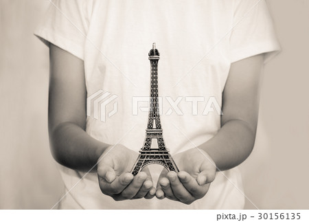 Open hand with a model the Eiffel Tower  30156135