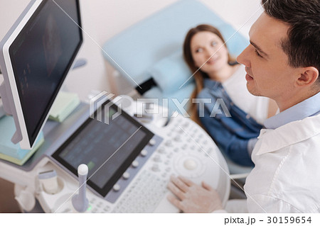 Handsome young practitioner providing checkup in Handsome young practitioner providing checkup in 30159654