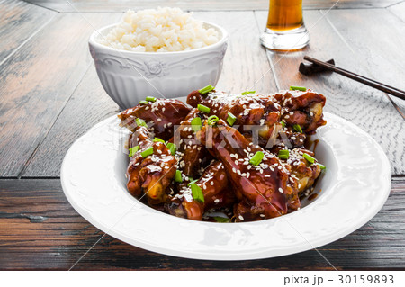 Crispy sesame chicken wings with a sticky sauce 30159893
