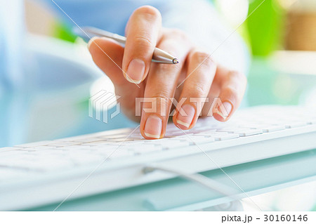 Woman office worker typing on the keyboard Woman office worker typing on the keyboard 30160146