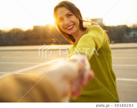 Follow me - happy young woman pulling guy's hand - hand in hand 30160283