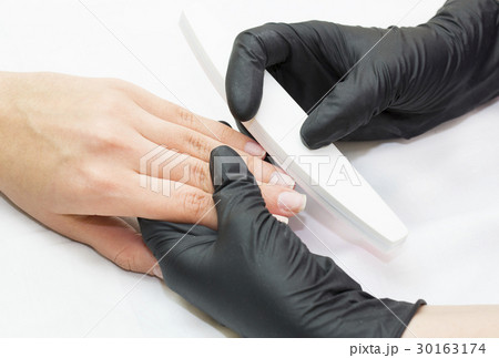 Woman doing manicure beauty salon  30163174