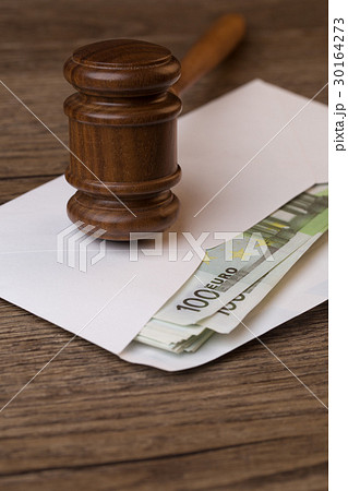 Wooden table with hammer, banknotes 30164273