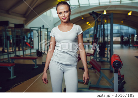 Beautiful girl standing in the gym dressed blank 30167185