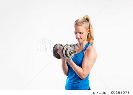 Attractive young fitness woman holding dumbell 30168073