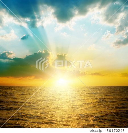bright sunset in clouds over orange sea 30170243