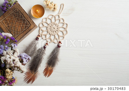 Wooden box and beige dream catcher, lit candle 30170483