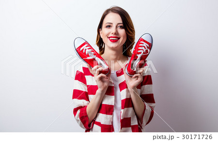 portrait of beautiful young woman with gumshoes portrait of beautiful young woman with gumshoes 30171726