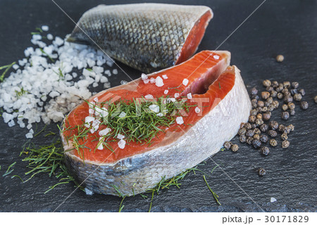 fresh salmon piece, pepper and salt on slate 30171829