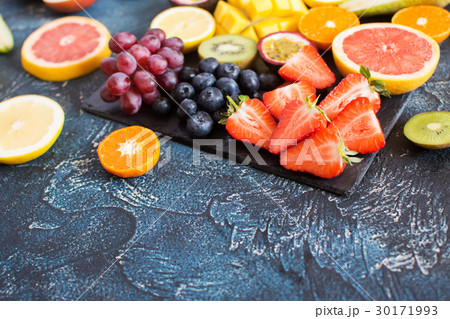 Raw fruits platter on the dark blue table 30171993