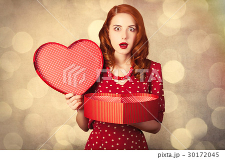 young woman with heart shaped gift 30172045