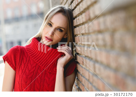 Young blonde woman walking in the street 30172170