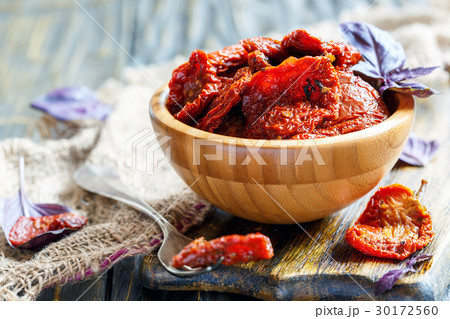 Sun-dried tomatoes and purple Basil in round bowl. 30172560