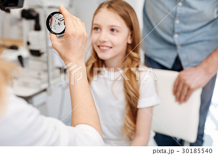 Precise experienced ophthalmologist observing eyes 30185540