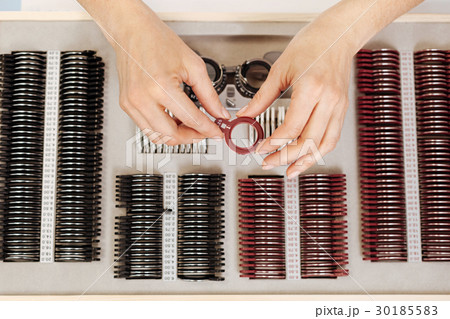 Precise experienced ophthalmologist examining the Precise experienced ophthalmologist examining the 30185583